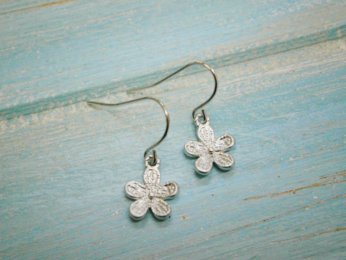 Matt Rhodium Plated Small Flower Pendant On Rhodium Plated French Earring Hooks.